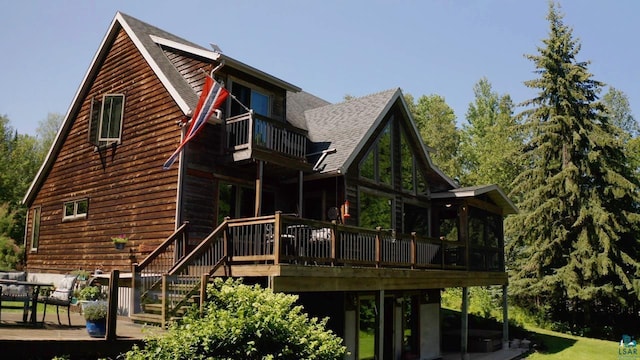 view of property exterior featuring a wooden deck