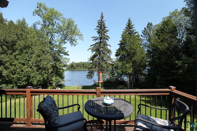 wooden deck featuring a yard and a water view