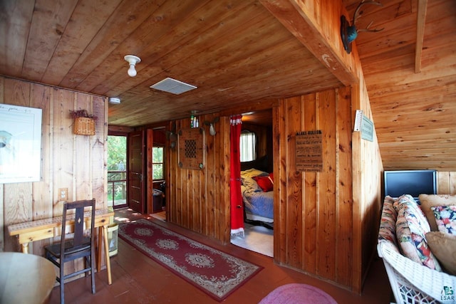 interior space with wood walls, lofted ceiling, and wooden ceiling