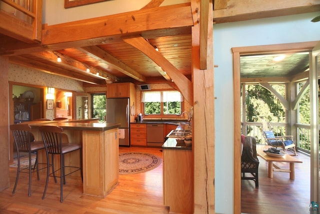 kitchen with stainless steel refrigerator, wooden ceiling, beam ceiling, light wood-type flooring, and paneled dishwasher