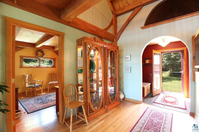 entryway featuring lofted ceiling with beams, wood ceiling, and wood-type flooring