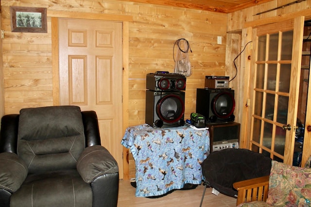 living room featuring light hardwood / wood-style flooring and wooden walls