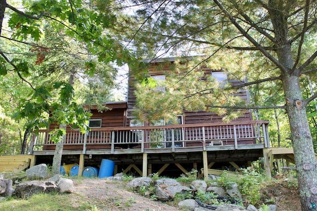 rear view of property featuring a deck