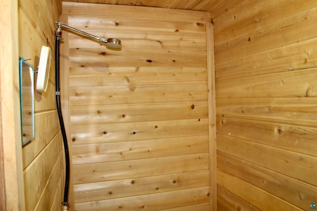 view of sauna with wooden ceiling and wood walls