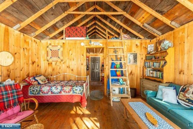 bedroom featuring wood walls, wood-type flooring, wood ceiling, and lofted ceiling