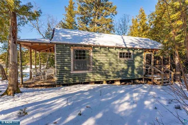 snow covered patio featuring a wooden deck