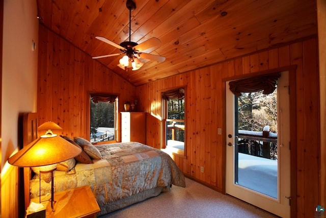 carpeted bedroom with wood walls, wooden ceiling, vaulted ceiling, and ceiling fan