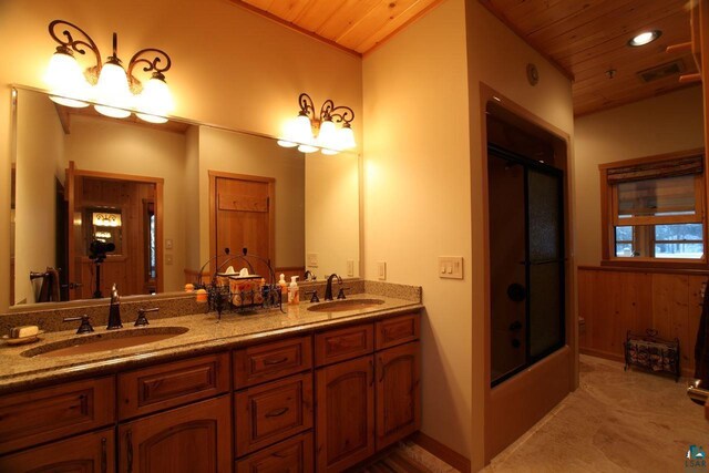 bathroom featuring wood ceiling, shower / bath combination with glass door, and dual bowl vanity