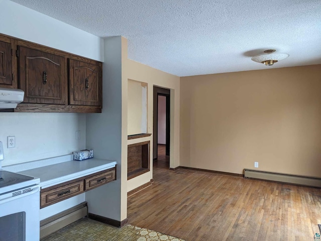 kitchen featuring extractor fan, hardwood / wood-style flooring, white range with electric cooktop, dark brown cabinetry, and a textured ceiling