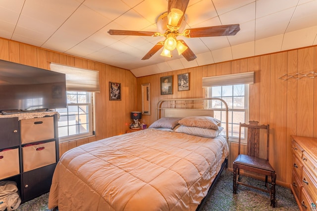 bedroom with wooden walls and ceiling fan