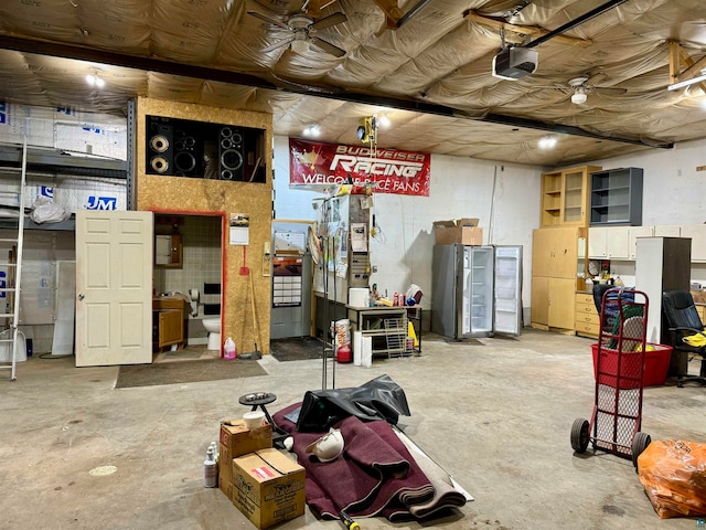 interior space with ceiling fan and a garage door opener