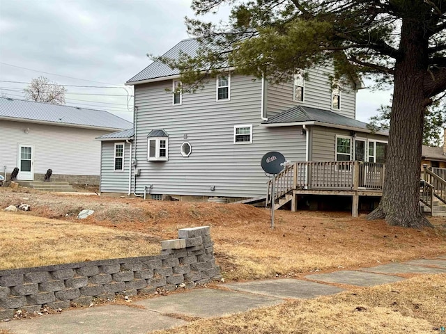 rear view of property featuring a deck