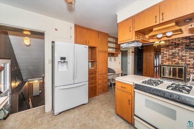 kitchen with a fireplace, white appliances, and light tile floors