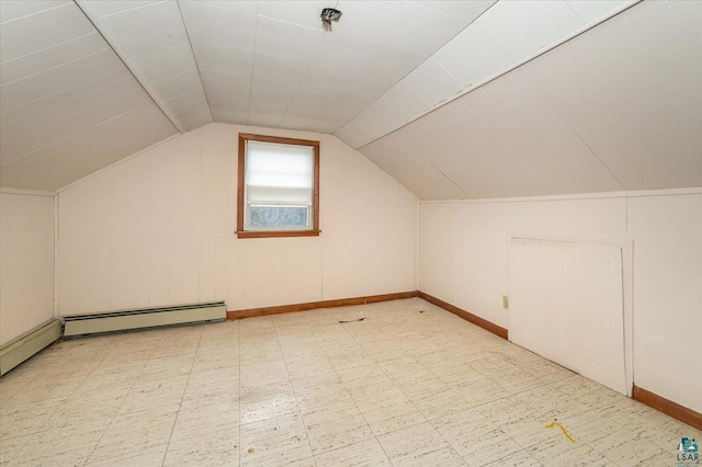 additional living space with vaulted ceiling, baseboard heating, and light tile floors