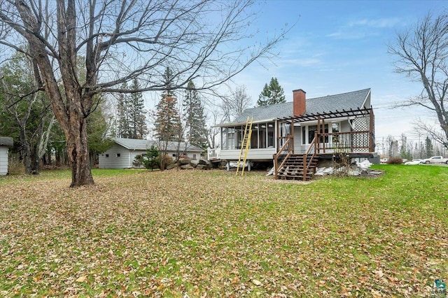 back of property featuring a pergola and a yard