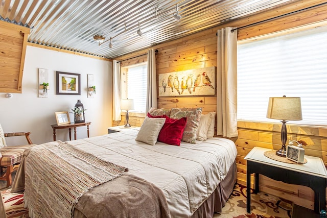 bedroom featuring wooden walls