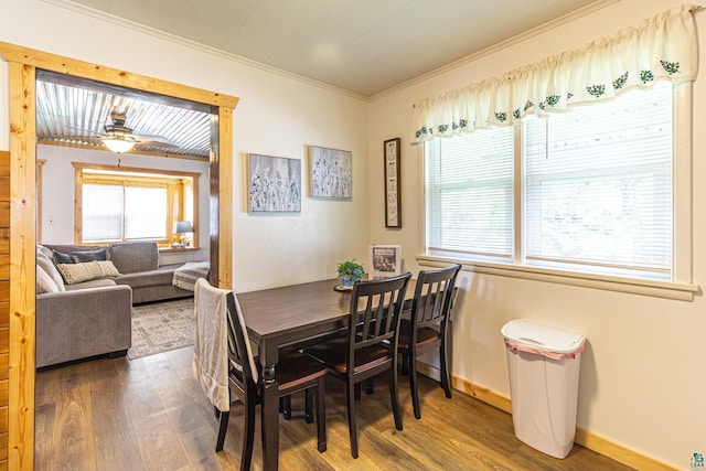 dining area with hardwood / wood-style floors, ceiling fan, and crown molding