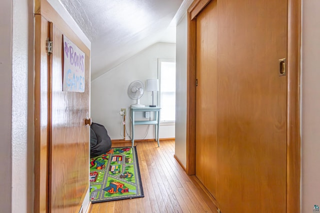 recreation room with lofted ceiling and light wood-type flooring