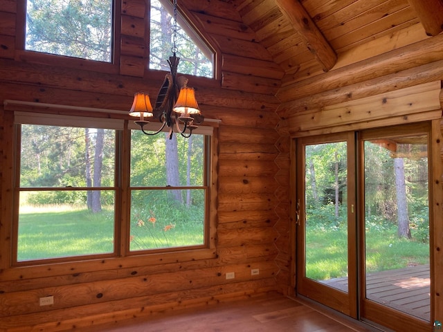 unfurnished dining area featuring lofted ceiling with beams, hardwood / wood-style flooring, log walls, wood ceiling, and a chandelier