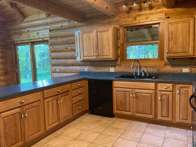 kitchen with rustic walls, sink, beamed ceiling, and black dishwasher