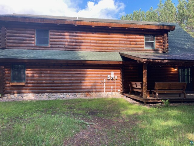 rear view of house with a yard and a deck