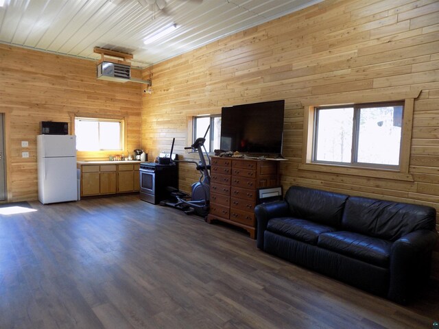 kitchen featuring rustic walls, sink, kitchen peninsula, black appliances, and custom exhaust hood