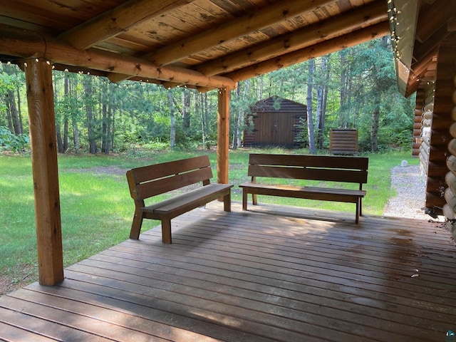 wooden deck with a yard and a storage shed