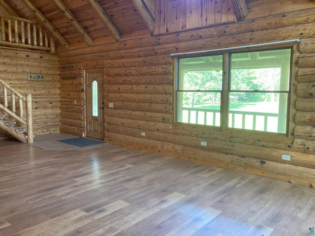 entryway featuring log walls, wooden ceiling, high vaulted ceiling, beamed ceiling, and hardwood / wood-style flooring