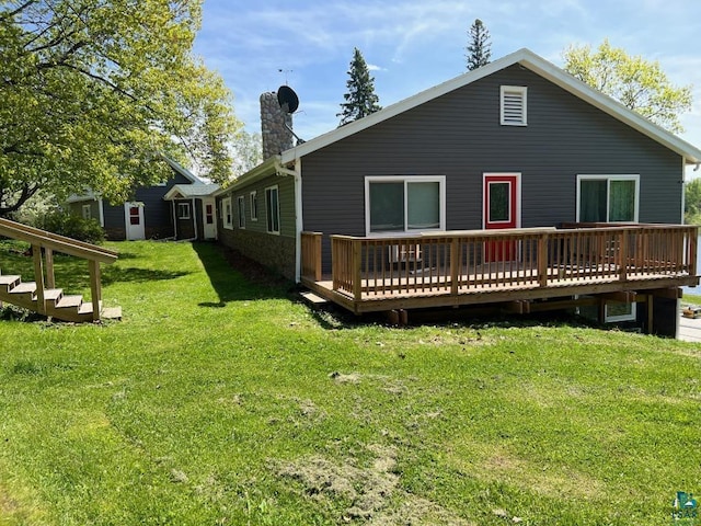 back of house with a yard and a deck