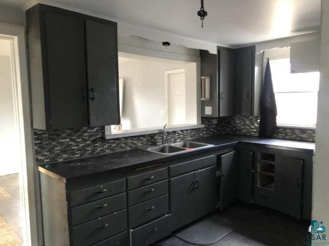 kitchen featuring tasteful backsplash and sink