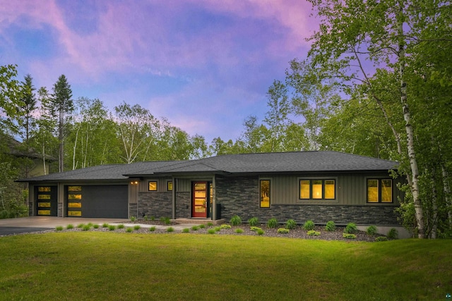 view of front of home with a lawn and a garage