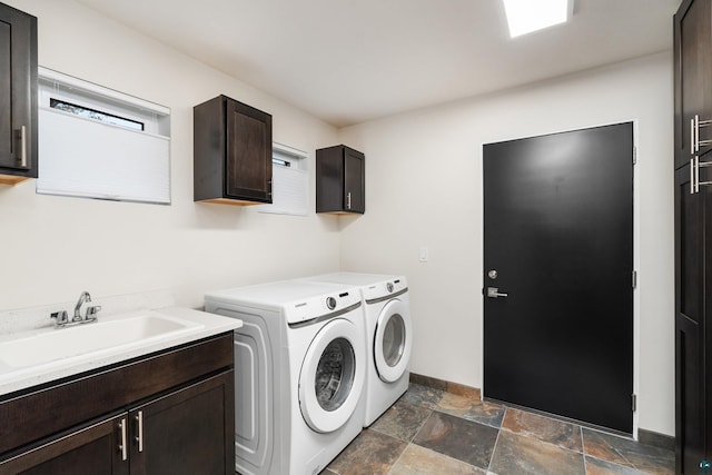 washroom with cabinets, sink, and washing machine and dryer