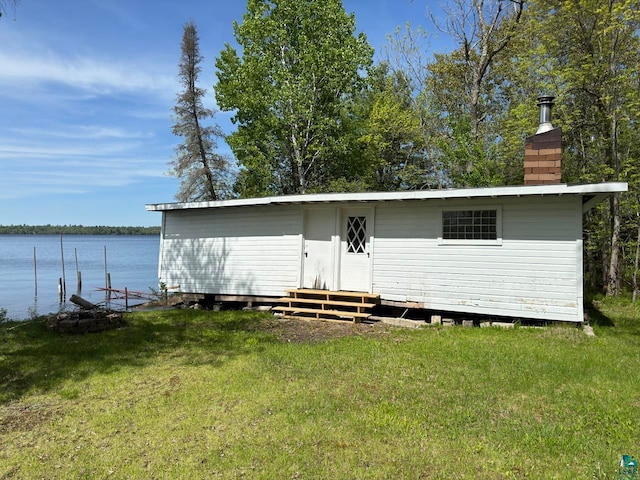 exterior space with a lawn and a water view