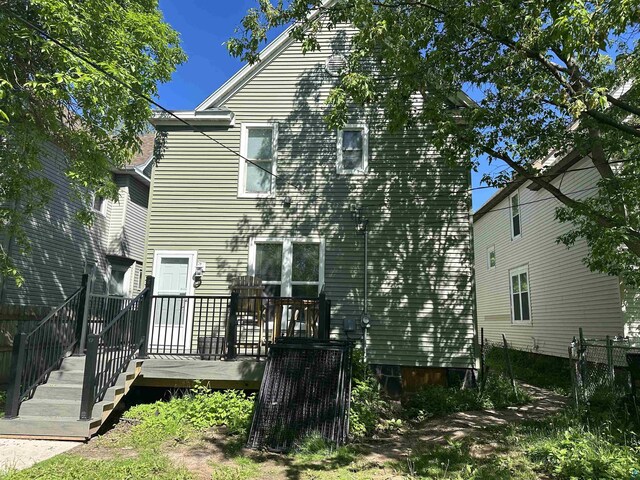 back of house with a wooden deck