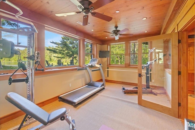 exercise room featuring ceiling fan, carpet floors, and wooden ceiling