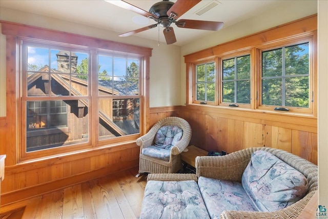 sunroom / solarium featuring ceiling fan