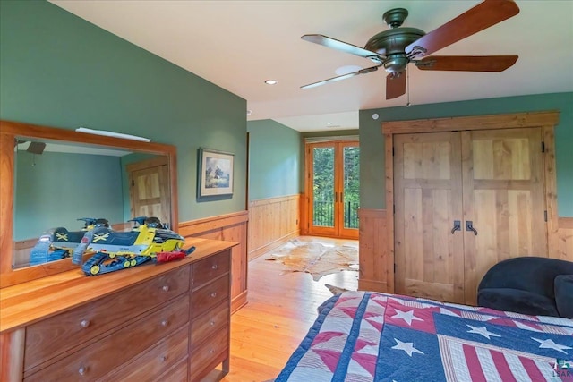 bedroom with light hardwood / wood-style floors, french doors, and ceiling fan