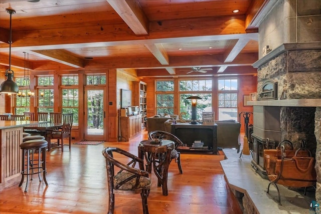 living room with ceiling fan, wooden ceiling, light hardwood / wood-style flooring, and beamed ceiling