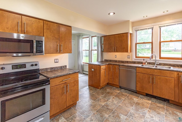 kitchen with appliances with stainless steel finishes, sink, and plenty of natural light