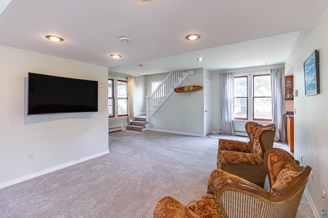 living room with plenty of natural light, carpet floors, and baseboard heating