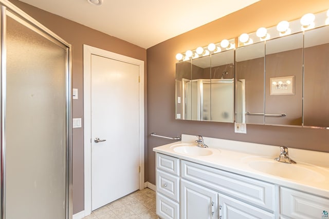 bathroom with vanity and a shower with door