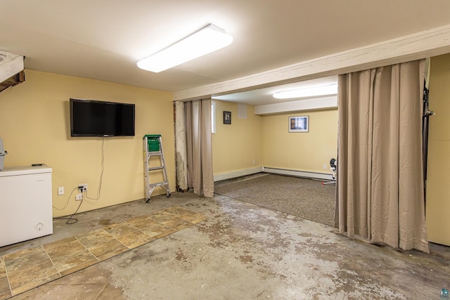 basement with fridge and baseboard heating