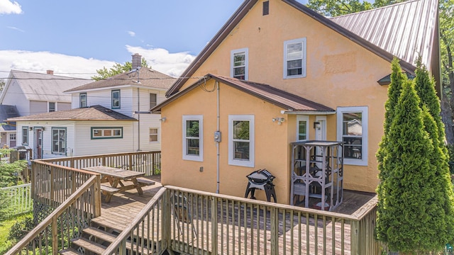 back of house with a wooden deck