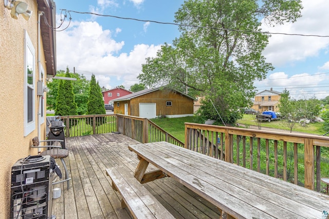 wooden terrace with a yard and an outbuilding