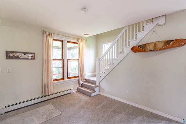 staircase with a baseboard heating unit and carpet floors