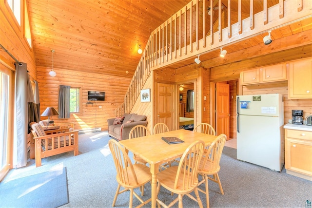 dining area with carpet flooring, rustic walls, wood ceiling, wooden walls, and high vaulted ceiling