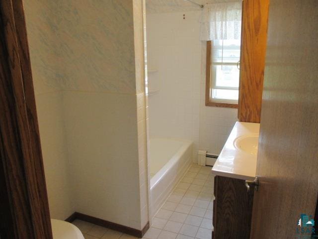 bathroom featuring tile patterned floors, a baseboard heating unit, toilet, and vanity