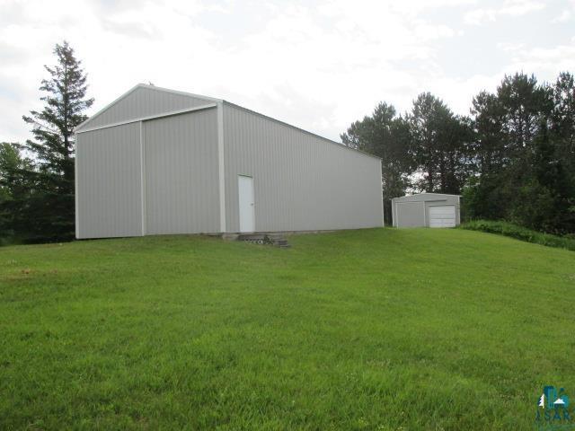 view of outbuilding featuring a yard