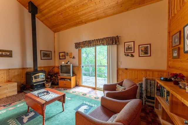 living room featuring wood ceiling, high vaulted ceiling, and a wood stove