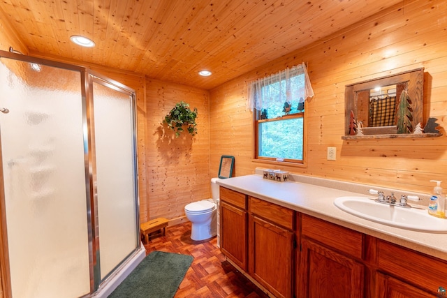 bathroom with wooden walls, parquet flooring, toilet, vanity, and wooden ceiling